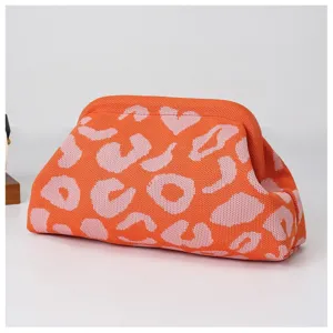Orange pink knit cloud clutch bag detail, fashionable women's casual pouch handbag accessory.
