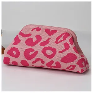 Knit cloud clutch bag detail, stylish pink leopard print design, soft textured bag.