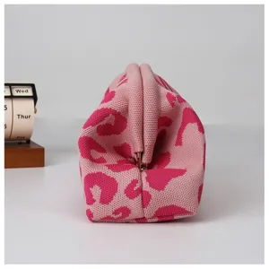 Pink leopard knit kiss-lock bag, stylish vintage women's cloud pouch side detail.