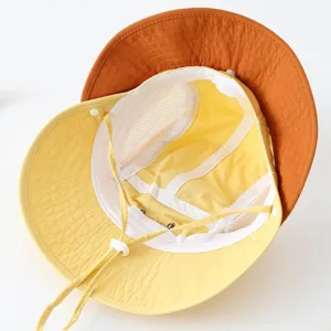 Kids summer sun hat detail, breathable mesh lining, yellow bucket hat with adjustable strap.