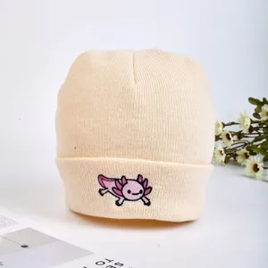 Beige knitted beanie hat with cute pink axolotl embroidery, warm winter wool cap for daily wear.