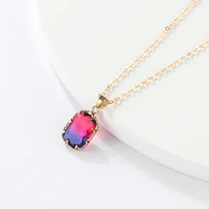Detailed view of a gorgeous rectangular gradient glass gemstone pendant necklace in gold chain.