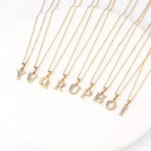 Close-up detail view of shiny gold stainless steel rhinestone alphabet letter pendant necklace.
