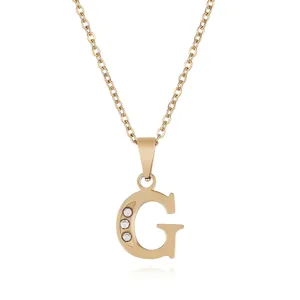 Close-up detail of gold-plated letter G pendant necklace featuring three sparkly crystal stones.