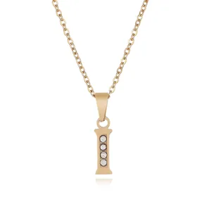 Gold stainless steel letter I pendant necklace detail featuring sparkling crystal stones.