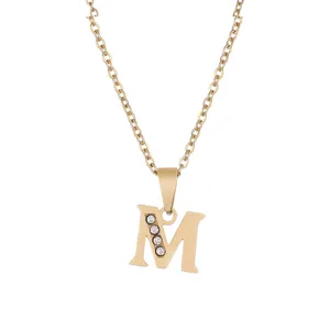 Close-up detail of the gold stainless steel letter M pendant necklace with sparkling rhinestones.