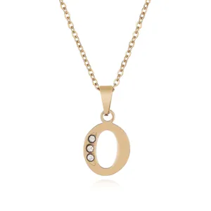 Close-up detail of the gold letter O pendant necklace with sparkling cubic zirconia stones.