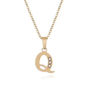 Detailed shot of gold letter Q pendant necklace with sparkly clear cubic zirconia stones.