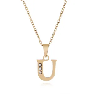 Gold letter U pendant necklace detail view, premium stainless steel with sparkly crystals.