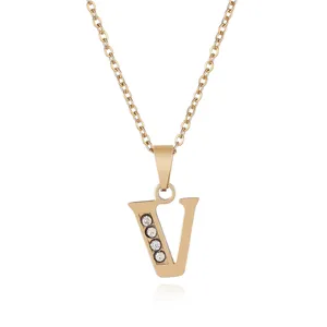 Gold stainless steel letter V pendant necklace with sparkling rhinestone details closeup.