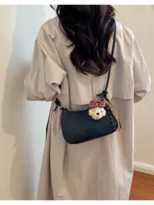Stylish black woven underarm shoulder pillow bag with cute plush bear pendant and bow.