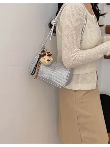 Silver woven underarm shoulder bag with cute teddy bear pendant, stylish casual daily purse.