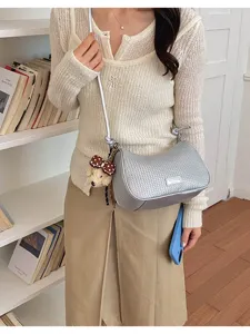 Korean style silver woven underarm shoulder pillow bag with cute bear pendant for women daily wear.