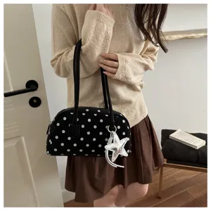 Chic black polka dot bowling shoulder bag with star charm, stylish daily commuter purse.