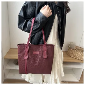 Detailed shot of a vintage burgundy leopard print tote bag with dual straps for women.