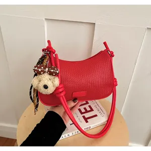 Red woven shoulder bag for women, stylish hobo underarm pillow bag with cute bear pendant.