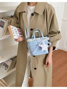 Chic blue plaid bucket bag with delicate lace trim and star pendant, stylish everyday purse.
