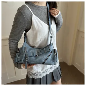 Trendy blue shoulder baguette bag for women, chic punk style with zippers and metal buckles.