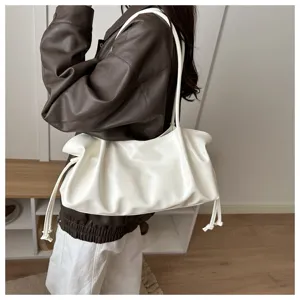 Detail view of a stylish white pleated leather shoulder bag for women commuting fashion.
