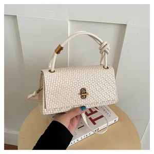 Detailed shot of stylish woven texture handbag with top handle and chic knot accent.