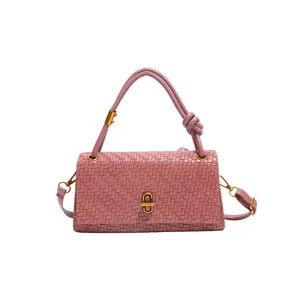 Stylish pink woven leather handbag for women, elegant top handle crossbody shoulder bag style.