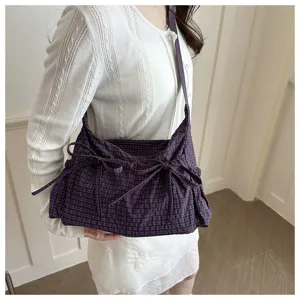 Vista dettagliata della borsa a tracolla a quadretti coreana con eleganti fiocchi.