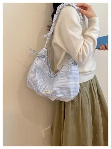Chic blue-white striped canvas shoulder bag for women, trendy casual hobo bag with large capacity.