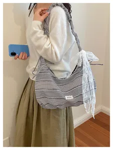 Casual striped canvas shoulder bag with lace bow detail, stylish large capacity commuter handbag.