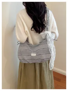 Casual striped canvas shoulder bag with delicate lace trim, stylish and roomy daily tote.