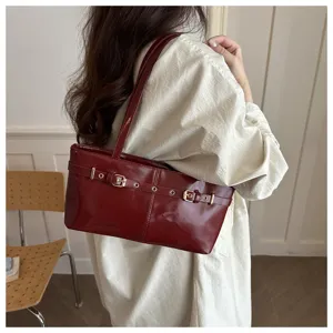 Burgundy faux leather shoulder underarm bag with chic metal buckle belt detail for women.