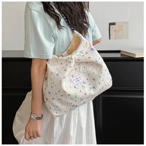Women floral shoulder crossbody bag, textured bubble fabric daily casual handbag stylish.