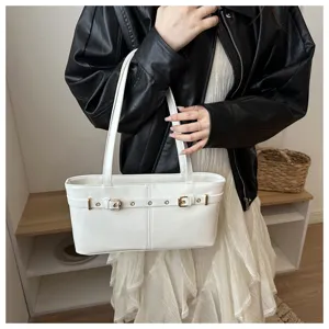 Detail shot of white shoulder bag with stylish belt buckle design and double top handles.
