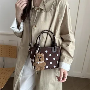 Stylish polka dot bucket bag with cute bear pendant, trendy women shoulder crossbody bag.