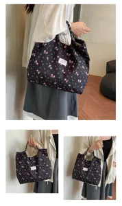 Black floral quilted tote bag detail view, showing soft bubble wrinkled fabric and large capacity.