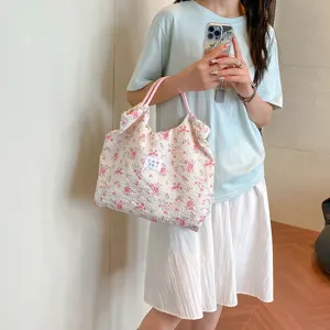 Floral quilted tote bag for women, large capacity shoulder handbag with pink handles.