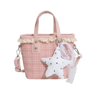 Pink houndstooth tweed bucket bag with lace trim, cute star charm, and shoulder strap.
