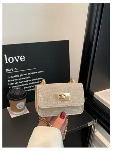 Gedetailleerd uitzicht van de fonkelende strass schoudertas met gouden ketting en sluiting.
