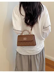 Brown quilted chain handle crossbody bag with interlocking lock design for women
