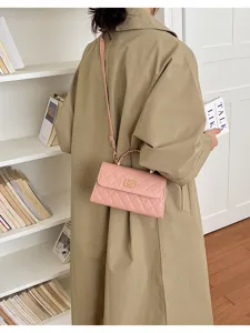 Chic pink quilted leather chain shoulder bag with elegant metal top handle for women daily.
