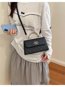 Black quilted shoulder bag with chain handle and metal clasp, chic fashion accessory for women.