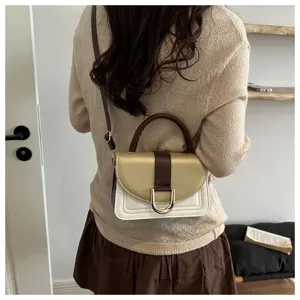 Vista dettagliata della elegante borsa a tracolla con blocco di colore e chiusura in metallo.