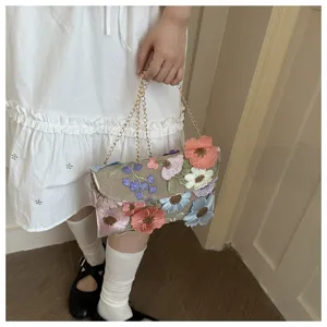 Floral embroidery chain cross body bag, detailed view showing colorful embroidered flowers.