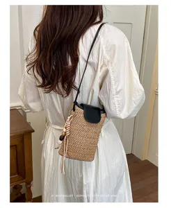 Vista detallada del bolso cruzado de paja de estilo coreano con cuentas de madera decorativas.