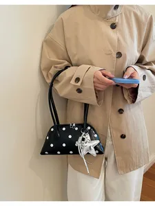 Black white polka dot shoulder bag with stylish star charm, perfect everyday commute handbag.