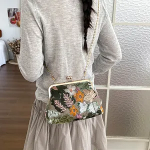 Chic Chinese style floral sequin shoulder bag with metal frame and chain strap for women.