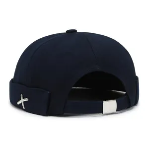 Dark blue brimless docker cap, unisex sailor hat with metal buckle and cross emblem.