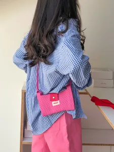 Stylish pink quilted crossbody bag for women, perfect for casual travel and daily use.
