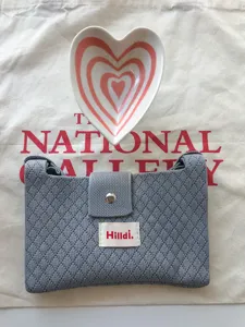 Grey knit crossbody bag small casual summer mobile phone bag cute heart bowl flat lay