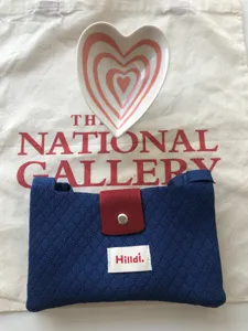 Knitted mini cross body bag paired with heart ceramic dish, casual daily knit phone pouch.