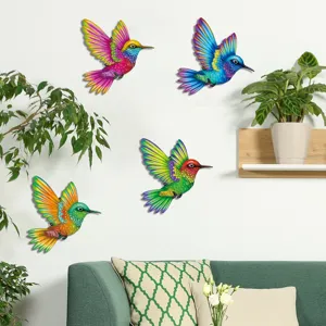 Detailed view of colorful metal hummingbird wall art hanging in a cozy living room decor.